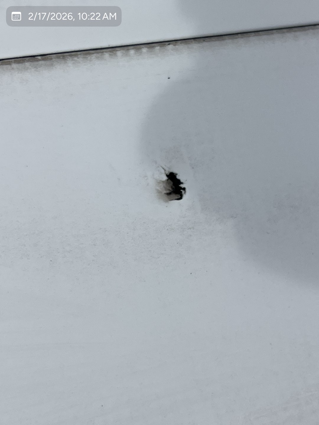 Close-up of a puncture in a commercial TPO roofing membrane