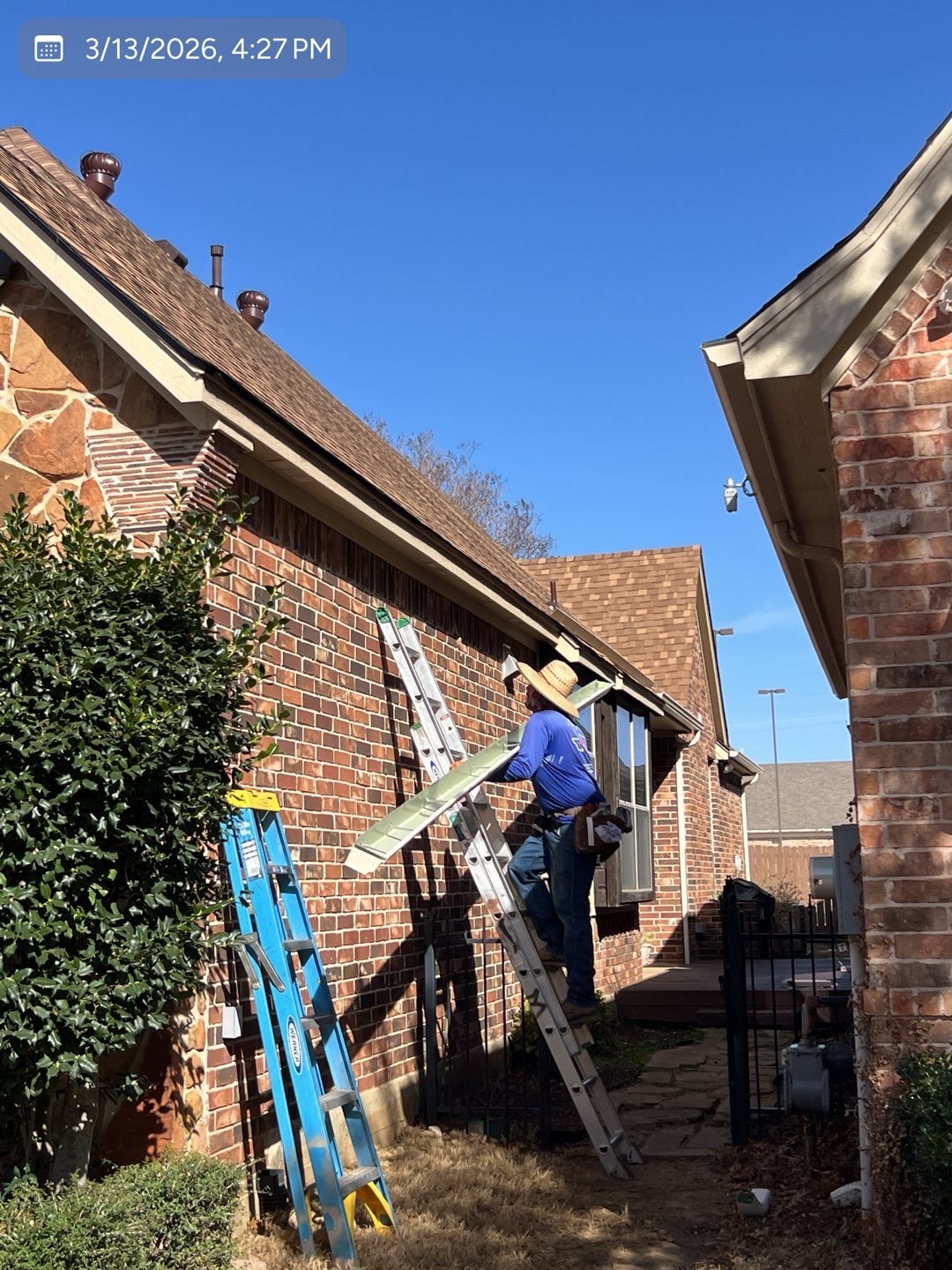 MVP crew member carrying a formed gutter during installation on a DFW home